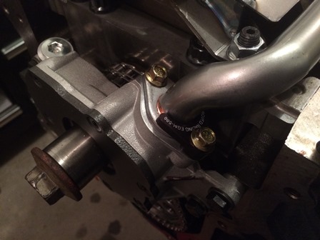 Install the oil pump pickup with the Improved Racing hold down clamp